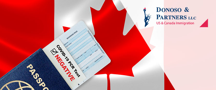 Canadian flag and passport with Covid-19 negative