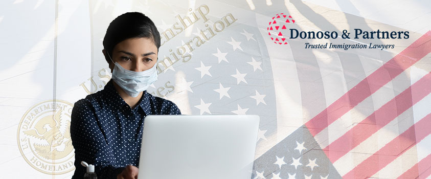 masked woman on laptop with USA flag in background